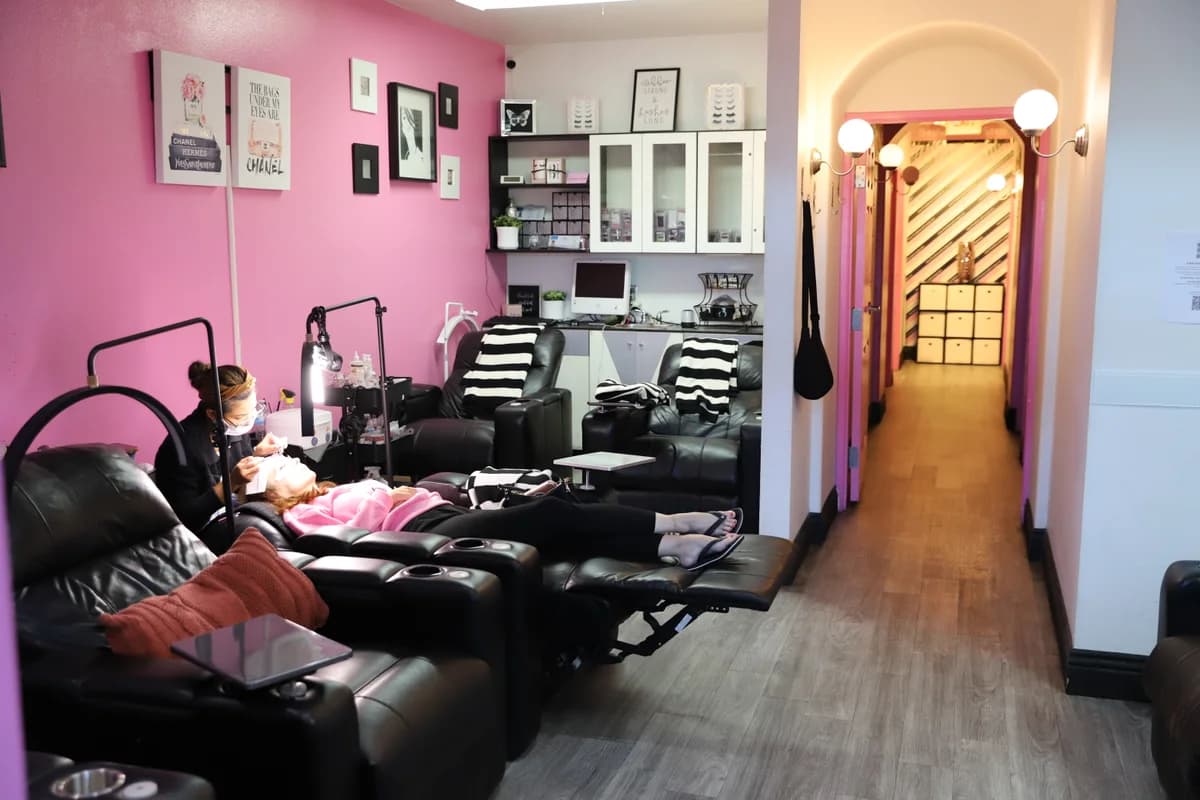 A JLon lash artist applying extensions in the lash room.