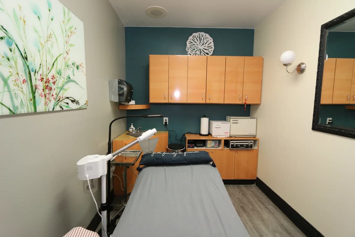 Green treatment room for waxing and massage.