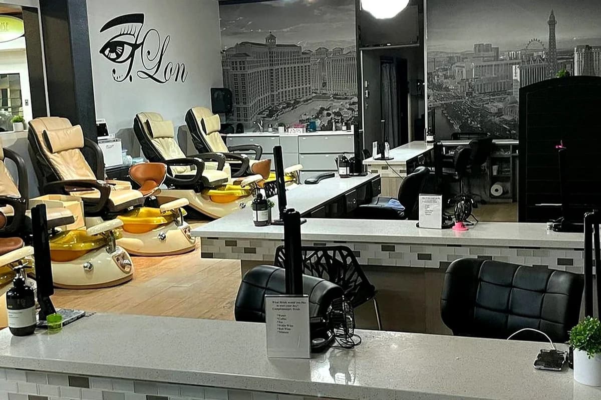 The nail bar and pedicure chairs under the JLon logo wall